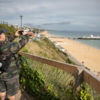 Kev taking a photo of the beach and ocean.