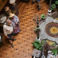 Birds eye view of inside of a manor house with various displays.