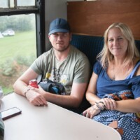 Rachel and Peter sitting on a train.