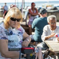 Two participants sat down at a seaside bench.