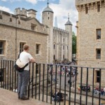 Participant leaning against the railings, overlooking the inside courtyard of the Tower of London.