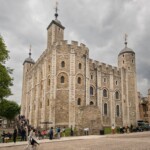 A photo of the White Tower at an angle, with crowds of people milling around.