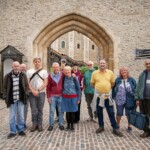 Group photo of participants smiling at the camera outside one of the entrances to the Tower of London.