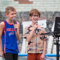 Two young boys singing karaoke at the Cultural Fayre.