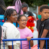 A group of kids standing in line for one of the attractions at the fayre.